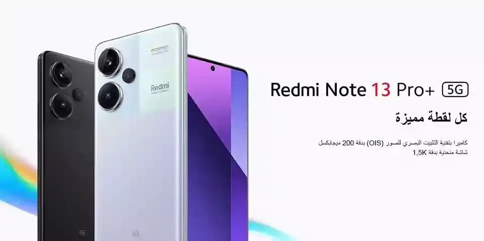 هاتف Redmi Note 13 Pro Plus 5G الذكي، تُظهر تصميمه الأنيق والعصري. يُعرض الجهاز على سطح أنيق وبسيط، مع إضاءة ناعمة ومنتشرة تُبرز هيكله المصنوع من سبائك الألومنيوم الفاخرة وشاشته عالية الجودة. يتميز الإطار بحواف حادة وتدرّج لوني مُلفت، بينما تبرز وحدة الكاميرا بشكل بارز، كاشفةً عن نظامها المُتطور ثلاثي العدسات. في الخلفية، يُضيف شعار REDMI لمسةً من التميّز